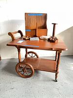 Overall view of wooden rolling tea cart with accessories on top and lower shelf visible