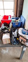 Overall lot on table showing bins, tool bag, screw box, hand tools