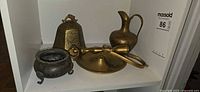 Group shot of all four decorative metal items on shelf