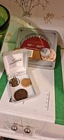 Overview showing commemorative set box, open case with coins and medallion
