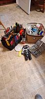 Overall lot view showing tool tote, storage bin, binoculars, tool cases and leash