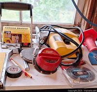 Workbench view showing DeWalt joiner, Milwaukee sander, Makita blade, Gorilla Gripper and small accessories