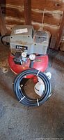 Overall view of Porter-Cable pancake air compressor with hose