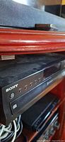 Front view of Sony CDP-CE500 unit in shelf