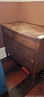 Front view showing three drawers and hardware