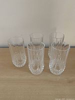 Front view of all five matching crystal highball glasses