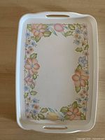 Top view of rectangular tray with floral border and handles