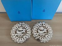 Two Birks trivets with blue presentation boxes