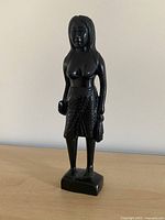 Front view of carved female wood figurine
