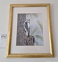 Full view of framed artwork showing image, mat and gold frame