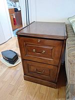 front view showing two drawers and brass-tone hardware