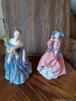 Front view of both Royal Doulton figurines showing colours and poses