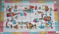 Full view of tea towel showing entire printed design and striped borders