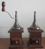 Front view showing both wooden boxes with pewter tops; pepper mill’s crank visible
