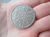 Reverse of 1957 UK two shillings coin showing Tudor rose design and denomination