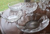 Four clear glass and crystal bowls displayed on table