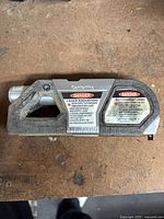 Centerline laser level front with warning labels visible