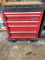 Front view of red Craftsman 5-drawer rolling tool chest with black organizer top and wheels