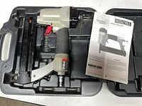 Brad nailer in carry case with manual