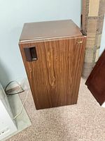 Front and top view of Sanyo brown woodgrain mini refrigerator
