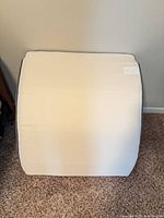 Front view of off-white memory foam wedge pillow showing overall shape and fabric cover