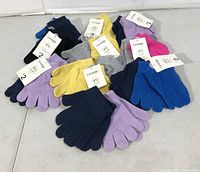 All ten pairs of George kids knit gloves with tags visible