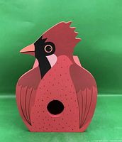 Front view showing cardinal shape, entrance hole, painted details