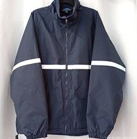 Front view of navy Tri-Mountain safety jacket showing zipper, stand collar, reflective chest stripe and sleeves