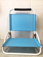 Front view of blue foldable beach chair showing seat, backrest, frame