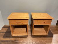 Front view of both Batten House bedside tables showing drawers, recessed pulls and open shelves