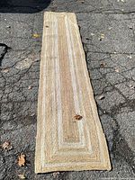 Full view of jute braided runner rug laid flat showing overall size and color