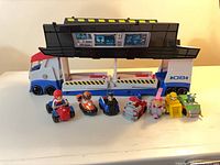 Overall view of transport truck with seven vehicles lined in front