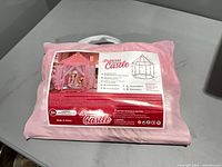 Front view of sealed pink carry bag containing Princess Castle play tent kit, showing product label