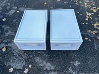 Top view of two identical translucent underbed drawers side by side