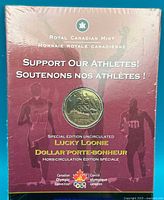 Front of sealed display card showing coin and support message