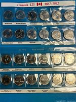 Front view of two plastic album sleeves holding full sets of 1992 Confederation quarters