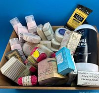 Overview of tray containing assorted soaps, tubes and 1 L body wash