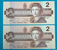 Obverse of both $2 Bank of Canada notes showing Queen Elizabeth II and consecutive serial numbers