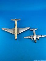 Underside view of both airplanes showing registrations and wear