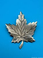 Front view of sterling silver maple leaf brooch