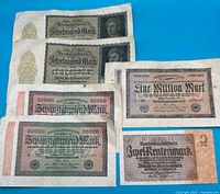 All six German banknotes laid out on blue background