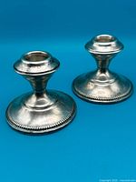 Pair of sterling silver weighted candlesticks front view
