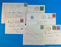 Overview of six Canadian mailed envelopes laid out on blue background