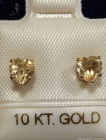 Front view of heart-cut citrine stud earrings on card showing 10 KT. GOLD marking