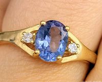 Ring on finger showing stones and band