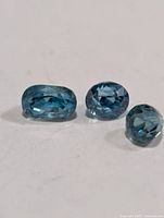 Three blue zircon gemstones close-up