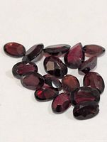 Group of faceted garnets on white background
