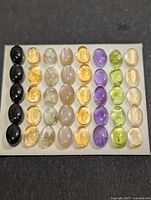 Display card showing all oval cabochons arranged by colour