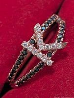 Top view showing letter K motif with clear CZ and black CZ split shank