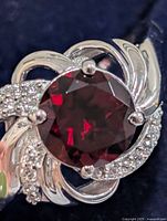 Front view showing garnet center stone and CZ accents